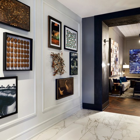lobby area with various painting on the wall