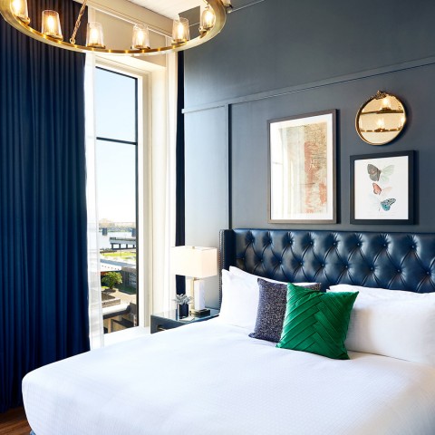 view of suite with a king bed with white sheets