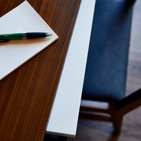 a desk with a notepad and a pen