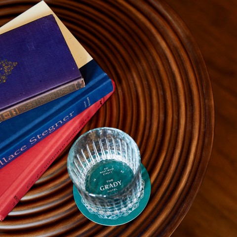 books and a glass of water on a table