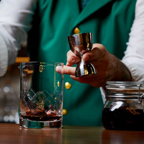 a bartender serving an alcoholic beverage
