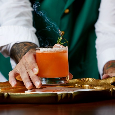 a bartender serving an alcoholic beverage