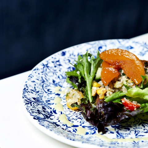 a gourmet dish on a blue and white plate