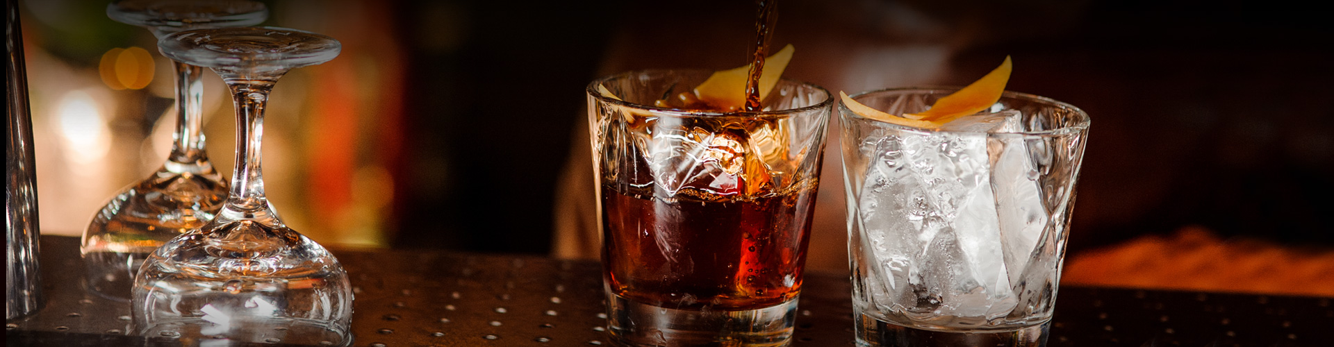 zoomed view of short glass with dark cocktail