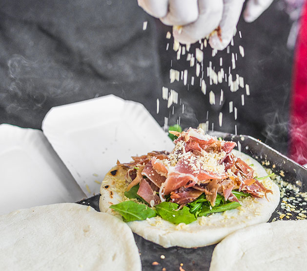 Arepa topped with lettuce, bacon & cheese