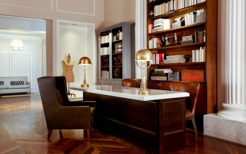 Room with wooden desk, leather chairs & book shelves