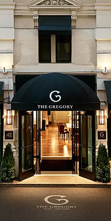 Gregory hotel entrance with black shade & glass doors