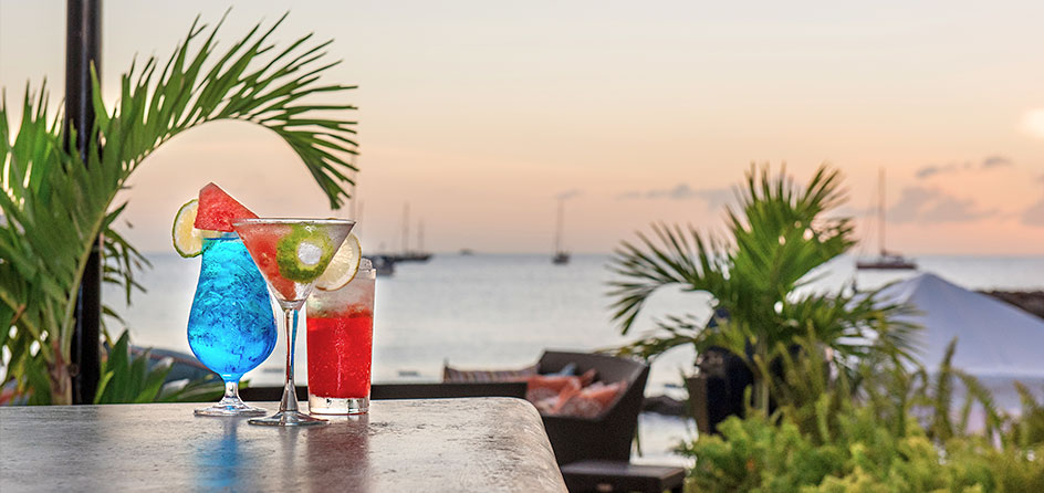 cocktails on a table with the ocean in the background