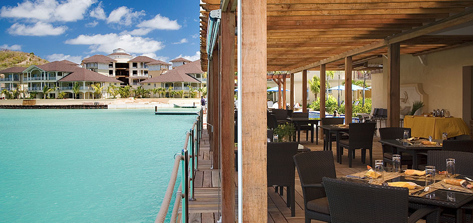 restaurant by the water with hotel in background