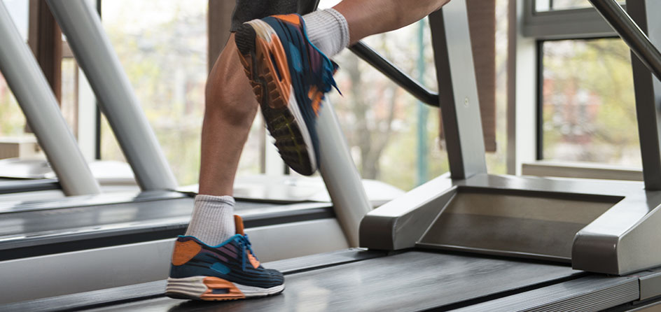 mans feet running on a treadmill