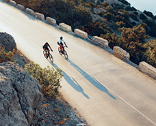 two bikers alongside the coastline