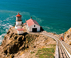 up above view of red roofed building by the ocean