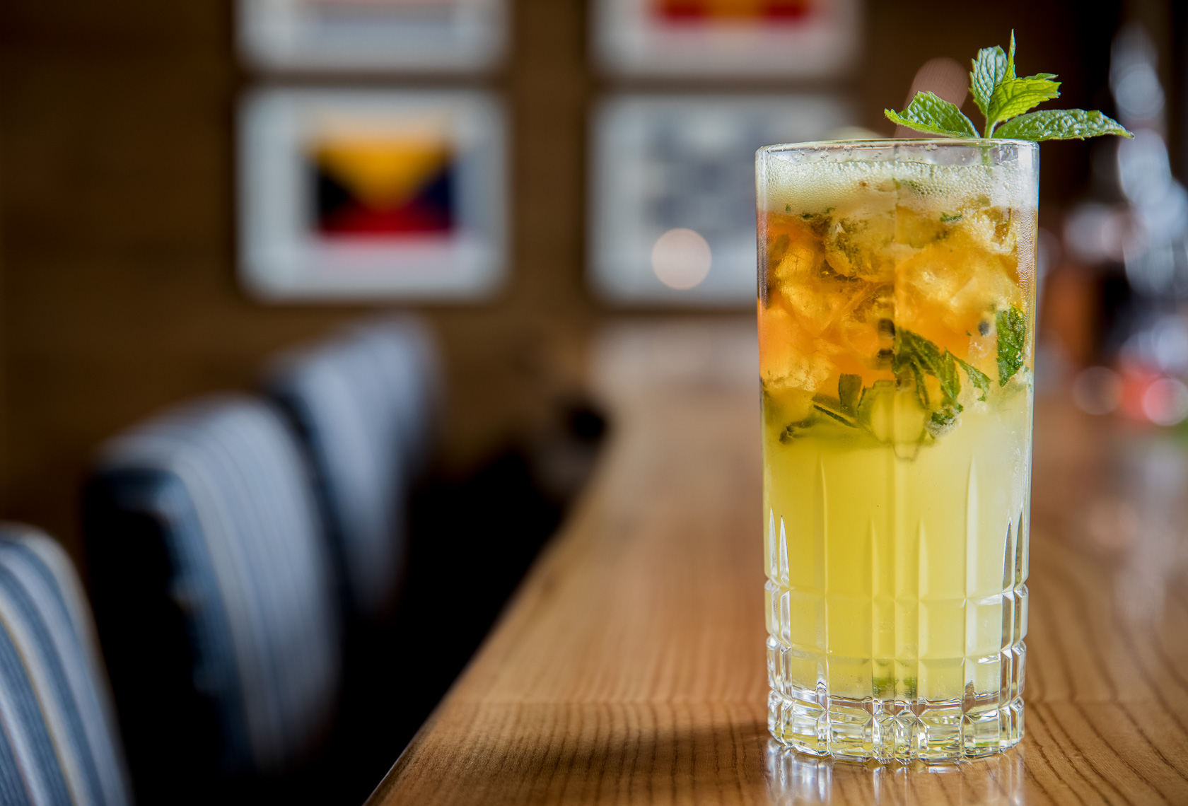 yellow cocktail garnished with mint 