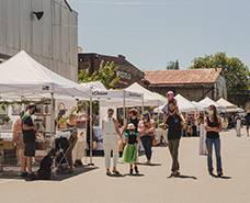 people walking around an open air marketplace