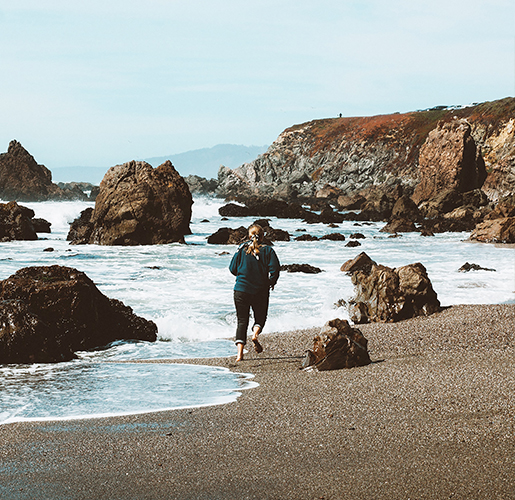 woman running on the beach dunes