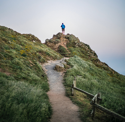 man hiked up at the top of a cliff