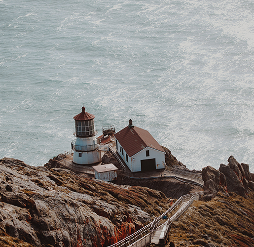 old look out building on a cliff near the ocean