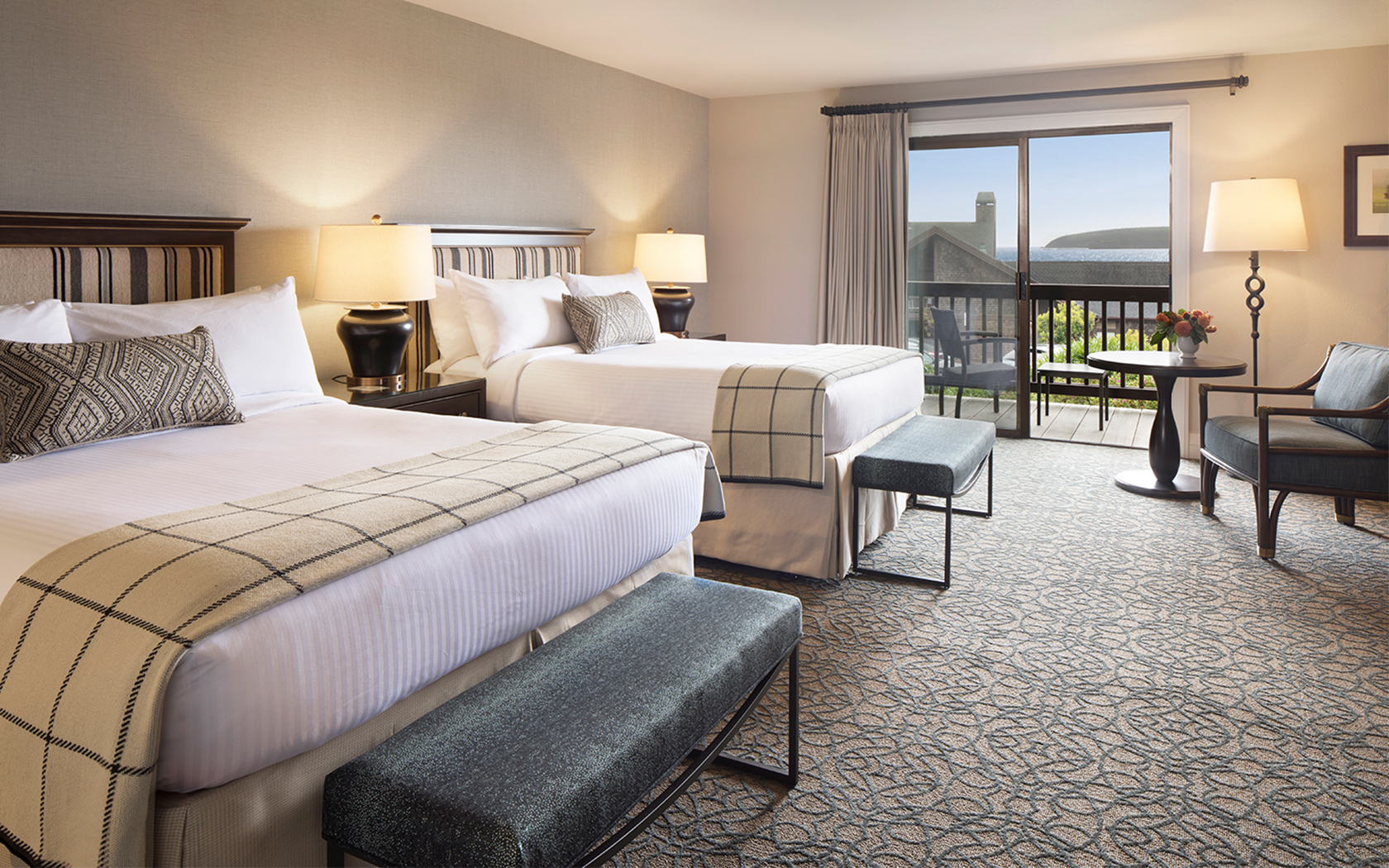 hotel room with two beds and an ocean view