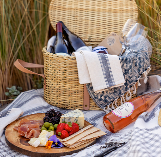 picnic basket set up on a blanket