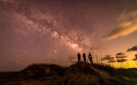 three people stargazing 