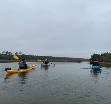 people kayaking on a river