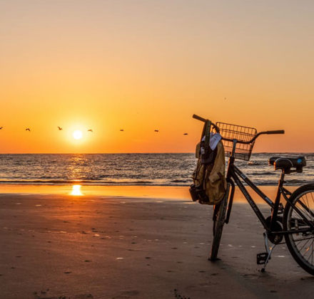 sunset photo on the beach with a bike