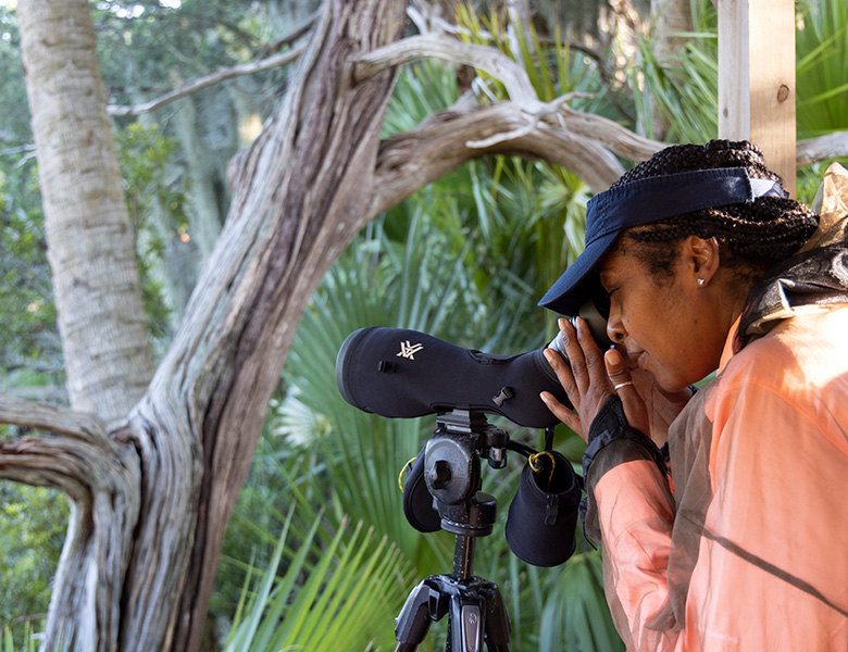 woman looking through binoculars 