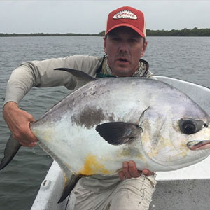 man holding a very large silver and white fish