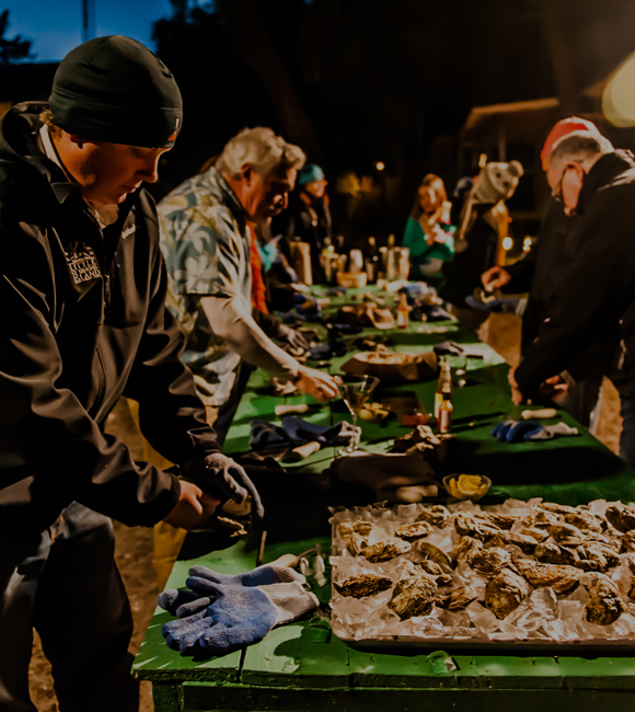 group of men shucking oysters