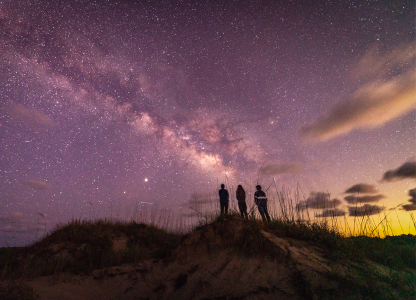 three people star gazing