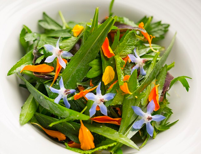 bowl of salad with flowers