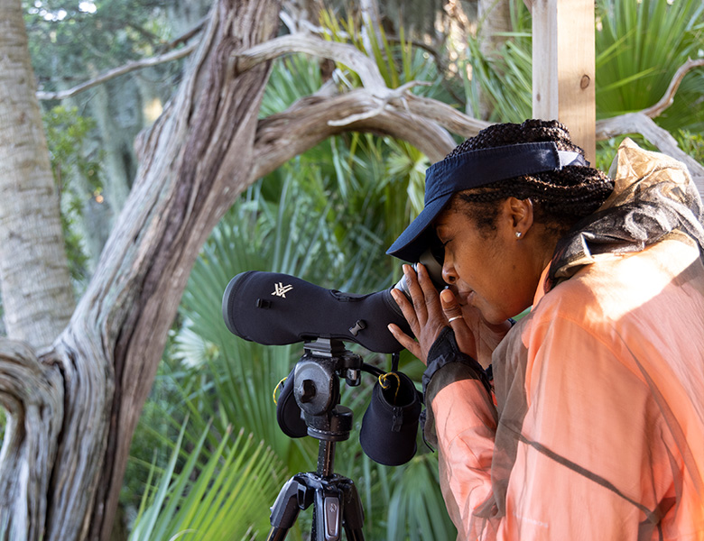 woman looking through binoculars
