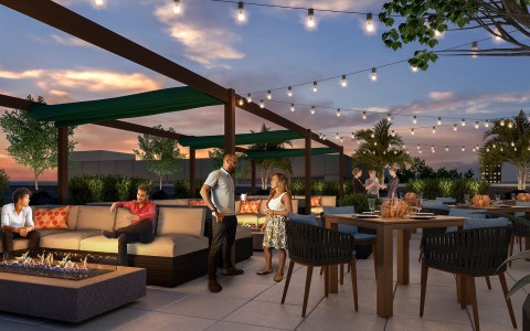 people talking and sitting on the rooftop patio decorated with lights and modern seating 