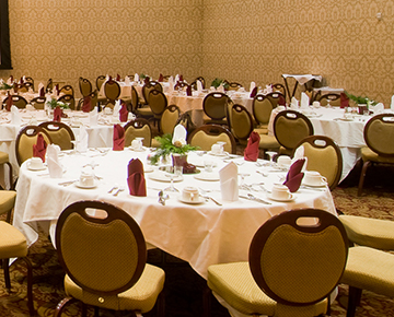 hotel meeting space filled with round tables and chairs