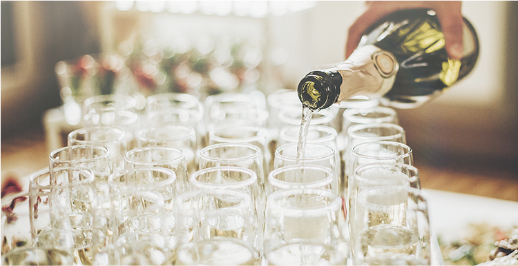 champagne being poured into champagne glasses