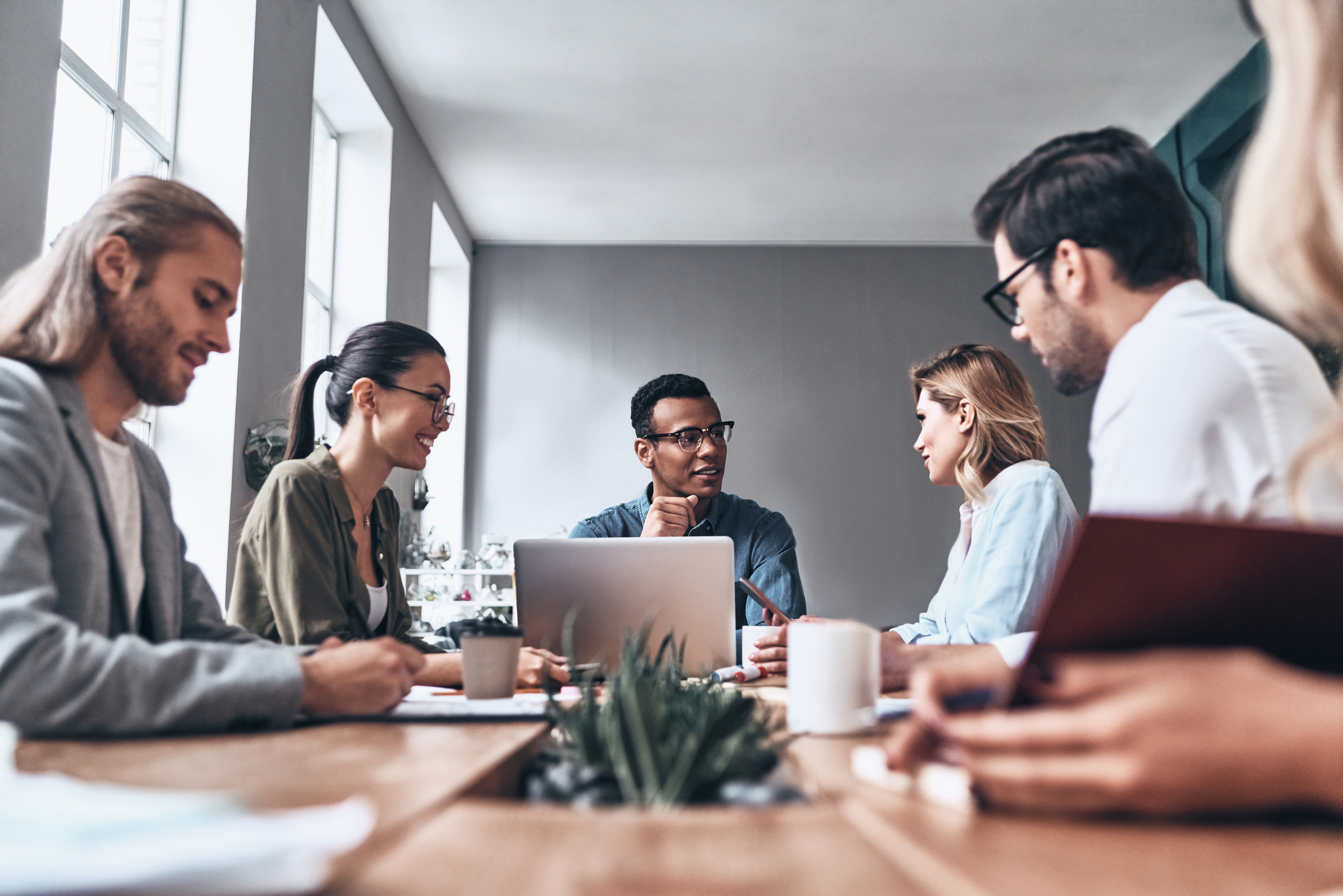 employees around table having a meeting