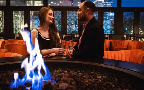 man and lady talking by the modern fireplace