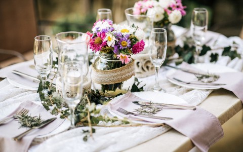 wedding table decor with flowers and greenery all around the center of the table
