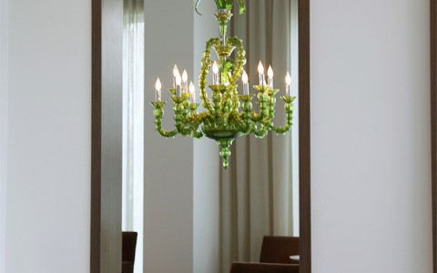 sneak peek into one of the meeting rooms that has a light green chandelier hanging