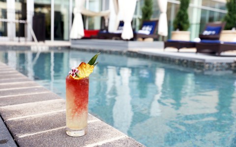 fruity cocktail placed next to the edge of the pool