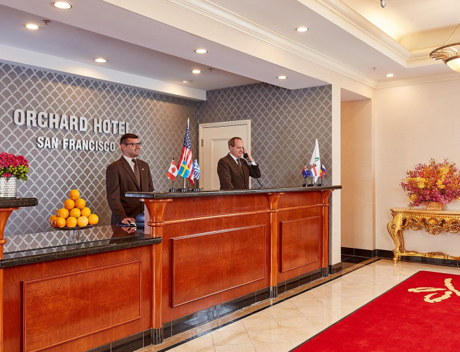 man at front desk of hotel with view of lobby