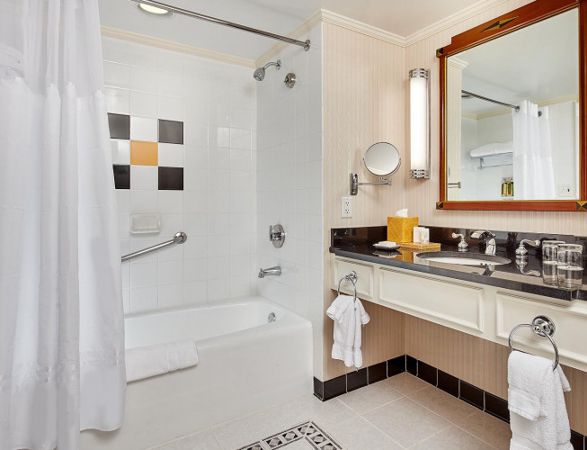 King Room Bathroom with white tub, white towels and white floors