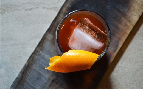 top shot of drink with orange peel on rim