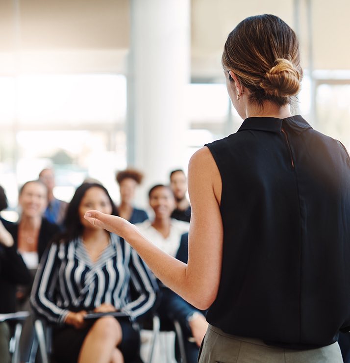 a woman presenting during a meeting