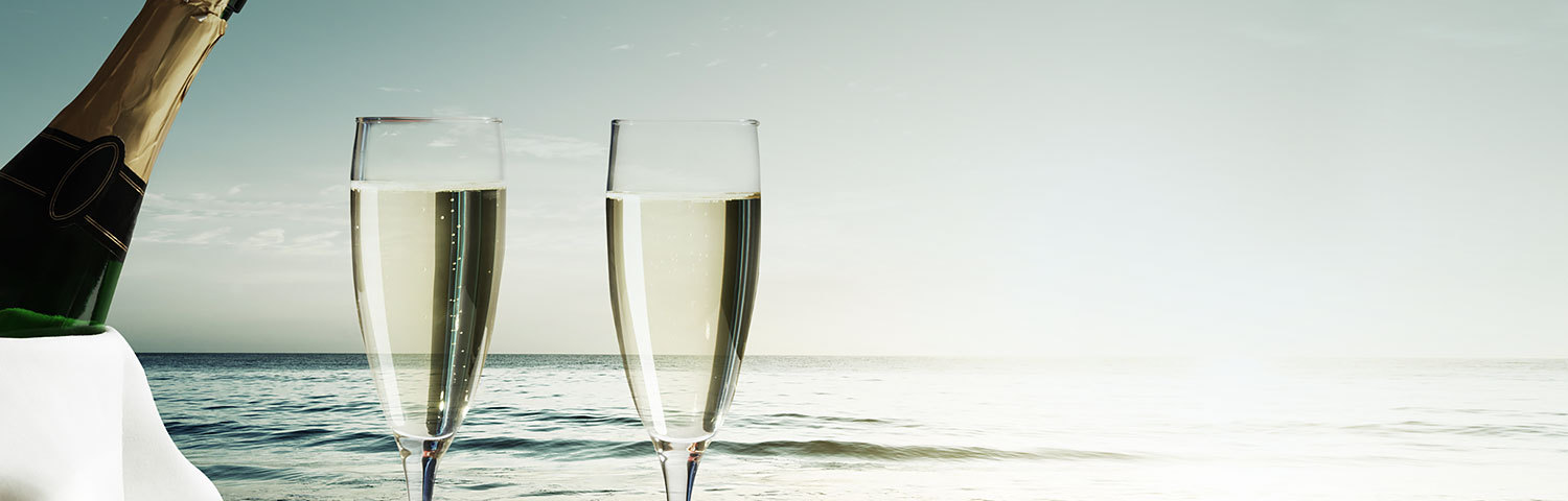 Champagne glasses on beach