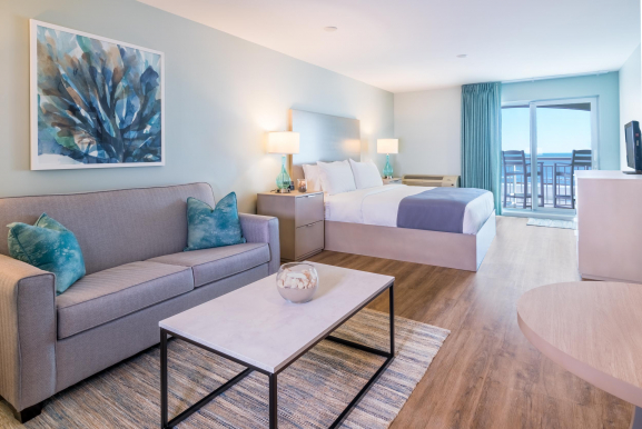 couch and king bed with balcony
