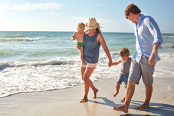 family walking along the beach