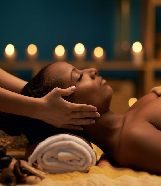 woman receiving a facial massage at a spa