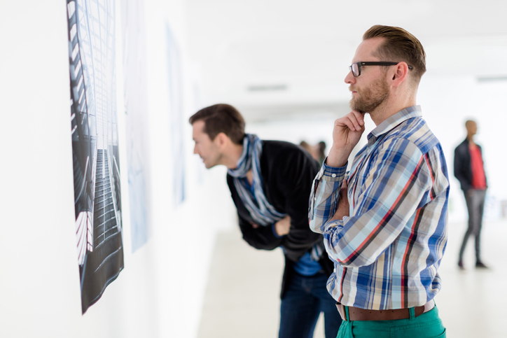 guy looking at artwork