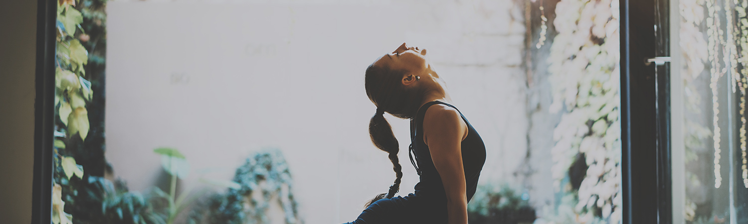Woman doing yoga pose on mat